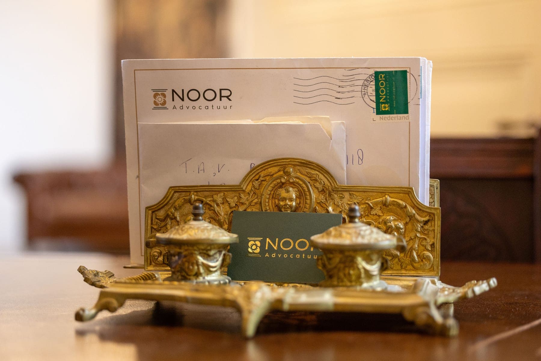 Correspondentie van NOOR Advocatuur achter een antiek inktstel